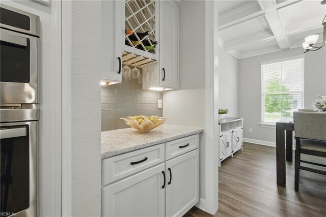 1028 Egret Ln, Suffolk, VA 23434 - kitchen featuring double oven, backsplash, coffered ceiling, beamed ceiling, and dark wood finished floors