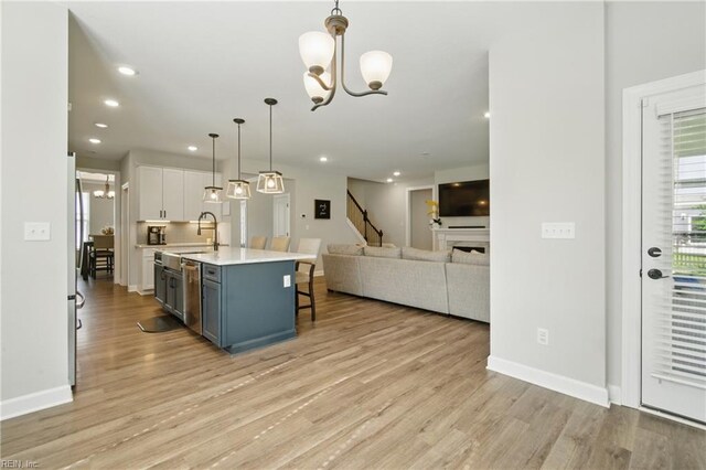 1028 Egret Ln, Suffolk, VA 23434 - kitchen featuring a chandelier, open floor plan, light countertops, a kitchen bar, and a sink