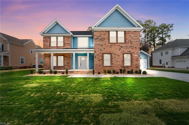 view of front of house featuring brick siding, a front lawn, concrete driveway, a garage, and a porch