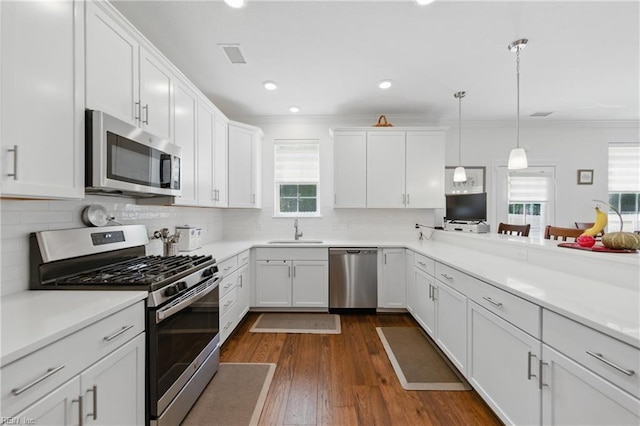 605 Middleton Way, Chesapeake, VA 23322 - kitchen featuring stainless steel appliances, a sink, ornamental molding, white cabinets, and backsplash