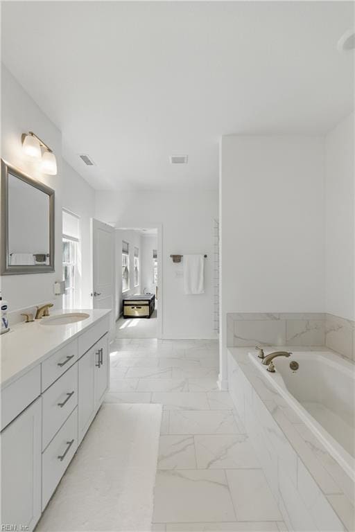 605 Middleton Way, Chesapeake, VA 23322 - bathroom with vanity, marble look tiles, and a bath