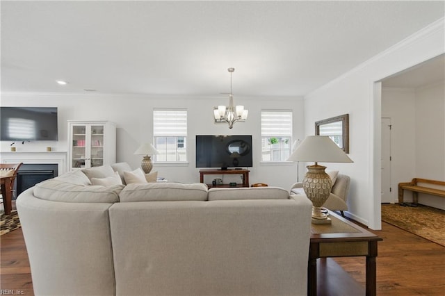 605 Middleton Way, Chesapeake, VA 23322 - living room featuring a chandelier, healthy amount of natural light, ornamental molding, a fireplace, and dark wood finished floors