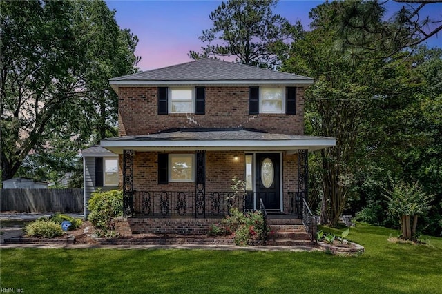 view of front of home featuring brick siding and a porch