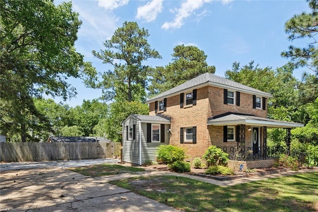 view of front facade featuring brick siding and covered porch