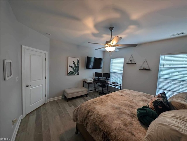 bedroom featuring wood finished floors, baseboards, and ceiling fan