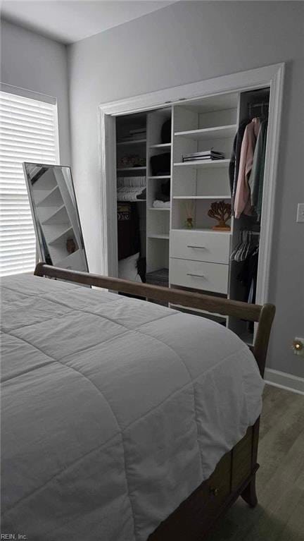 bedroom with wood finished floors and baseboards