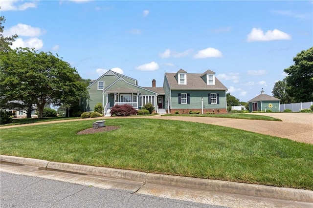 cape cod house with a front lawn and driveway