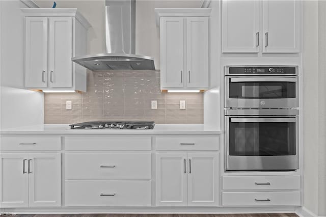224 Preserve Way, Suffolk, VA 23434 - kitchen featuring wall chimney exhaust hood, appliances with stainless steel finishes, white cabinetry, light countertops, and backsplash