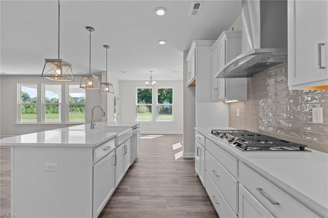 224 Preserve Way, Suffolk, VA 23434 - kitchen featuring wall chimney exhaust hood, appliances with stainless steel finishes, a sink, baseboards, and white cabinets