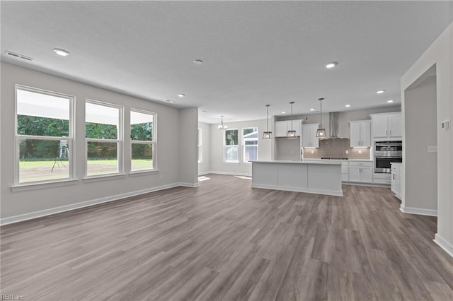 224 Preserve Way, Suffolk, VA 23434 - unfurnished living room featuring wood finished floors, baseboards, recessed lighting, and a chandelier