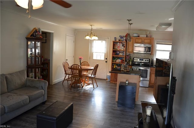 703 Houston Ave, Hampton, VA 23669 - living room featuring crown molding, plenty of natural light, a ceiling fan, dark wood-style flooring, and a chandelier