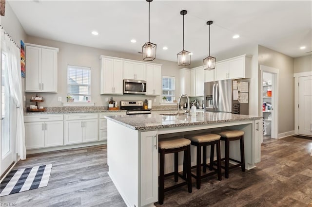 110 Sea Hero Ct, Suffolk, VA 23435 - kitchen featuring appliances with stainless steel finishes, a sink, wood finished floors, white cabinets, and recessed lighting
