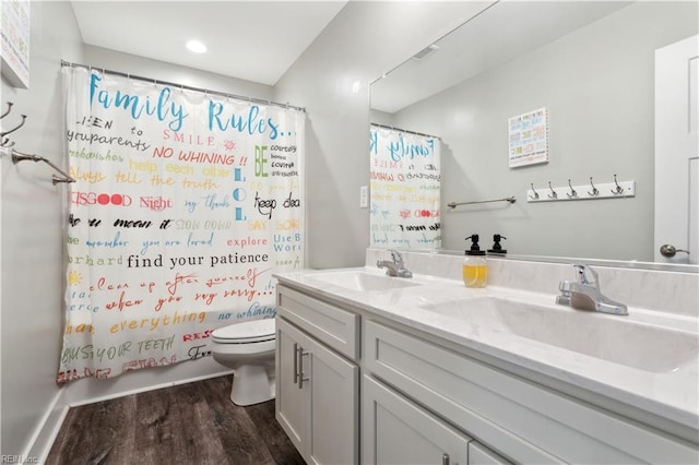 110 Sea Hero Ct, Suffolk, VA 23435 - bathroom featuring wood finished floors, toilet, double vanity, shower / bathtub combination with curtain, and recessed lighting