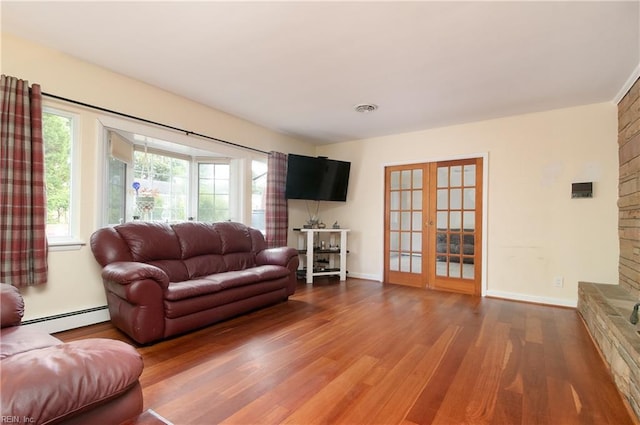 101 Stadium Dr, Chesapeake, VA 23322 - living room featuring baseboard heating, wood finished floors, french doors, and baseboards