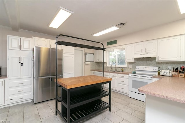 101 Stadium Dr, Chesapeake, VA 23322 - kitchen featuring white appliances, a sink, light tile patterned floors, under cabinet range hood, and ornamental molding