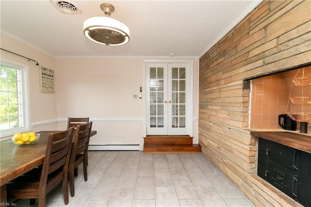 101 Stadium Dr, Chesapeake, VA 23322 - dining room featuring french doors, crown molding, baseboard heating, light tile patterned floors, and wooden walls