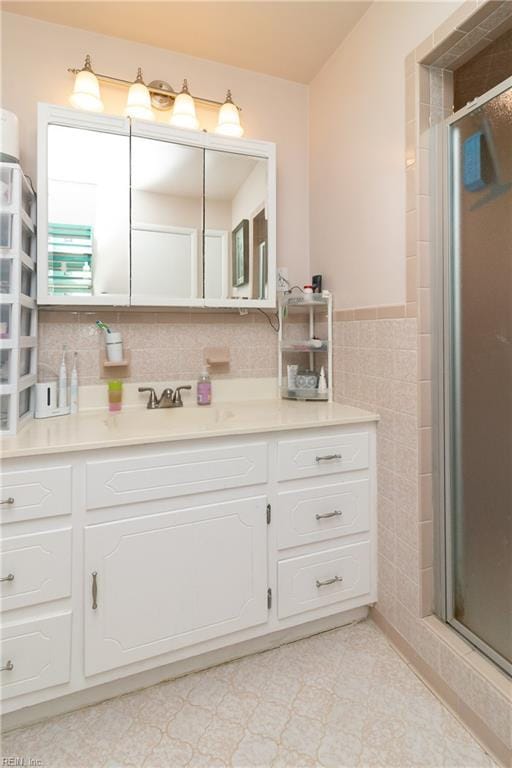 101 Stadium Dr, Chesapeake, VA 23322 - bathroom featuring tile walls, vanity, a stall shower, and wainscoting