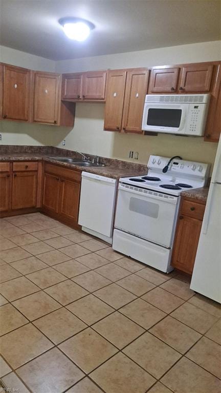 154 Jenness Ln Unit F, Newport News, VA 23602 - kitchen with white appliances, dark countertops, light tile patterned flooring, and brown cabinetry
