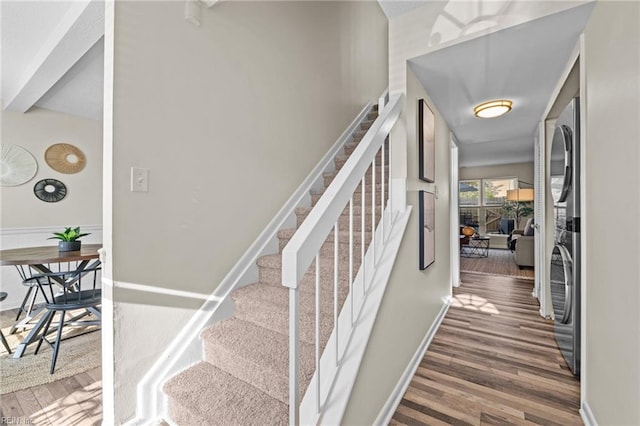 stairway featuring wood finished floors and baseboards