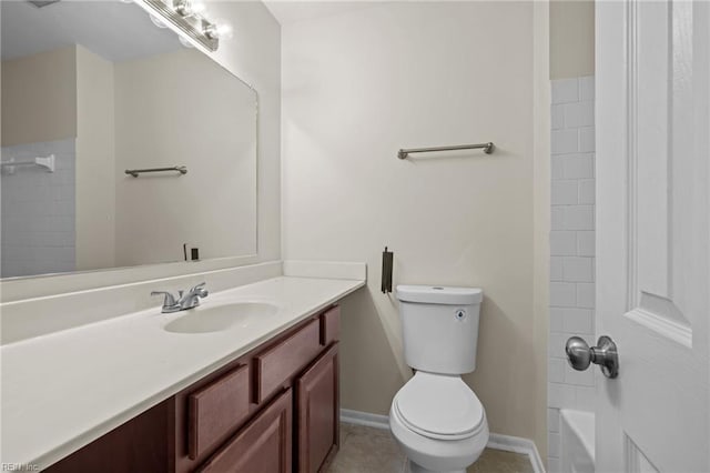 bathroom with vanity, toilet, baseboards, and tile patterned floors