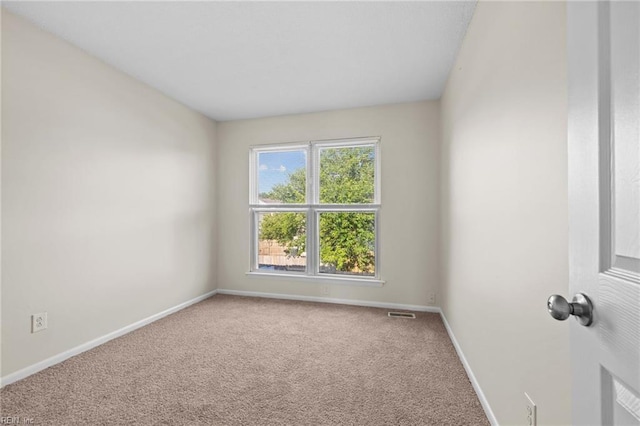 carpeted empty room with baseboards