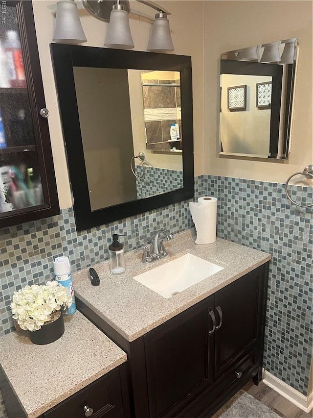 bathroom featuring vanity and tasteful backsplash