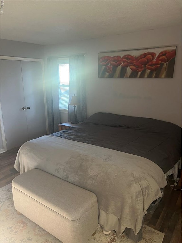 bedroom featuring wood finished floors and a closet