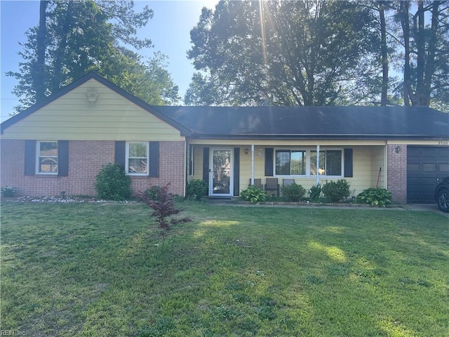 ranch-style house with brick siding, an attached garage, and a front yard