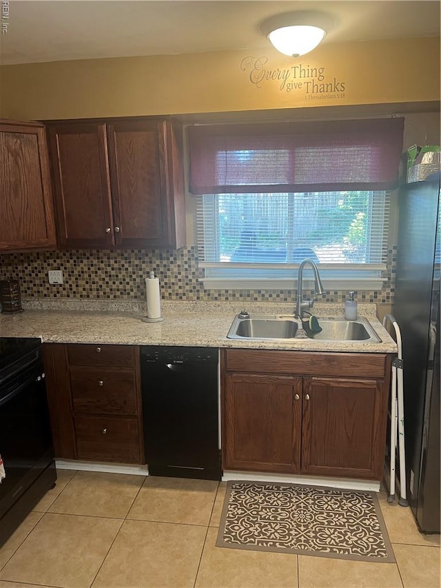 kitchen with black appliances, a sink, healthy amount of natural light, and backsplash