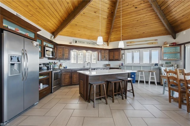 3616 Sandfiddler Rd, Virginia Beach, VA 23456 - kitchen with stainless steel appliances, wooden ceiling, open shelves, a kitchen island with sink, and tasteful backsplash