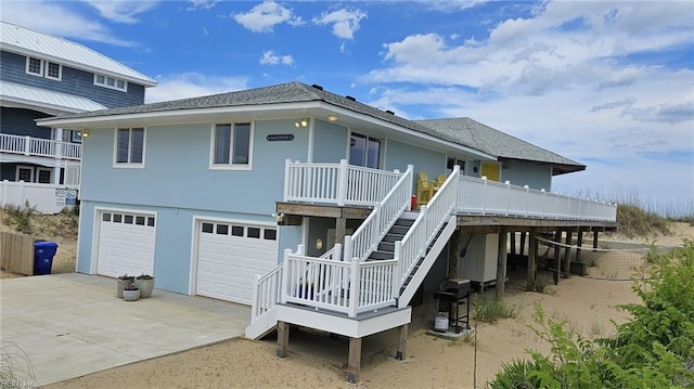 3616 Sandfiddler Rd, Virginia Beach, VA 23456 - back of house featuring concrete driveway, an attached garage, stairs, roof with shingles, and a deck