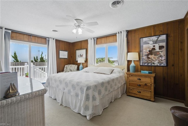 3616 Sandfiddler Rd, Virginia Beach, VA 23456 - bedroom with access to exterior, wooden walls, light carpet, a textured ceiling, and a ceiling fan
