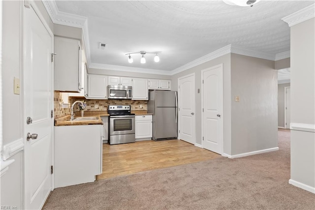 1048 Wilmington St, Norfolk, VA 23505 - kitchen with stainless steel appliances, light colored carpet, white cabinetry, tasteful backsplash, and a sink