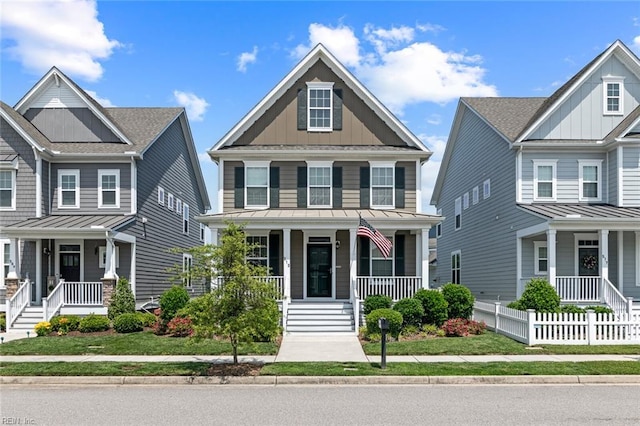 513 Simpson Ln, Chesapeake, VA 23323 - craftsman-style house with covered porch, board and batten siding, and fence
