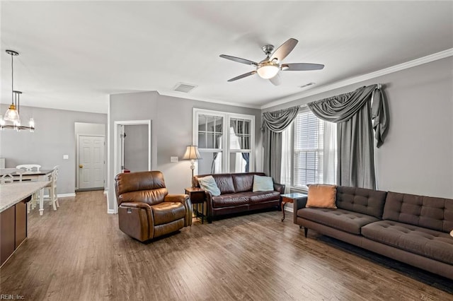 513 Simpson Ln, Chesapeake, VA 23323 - living area with ceiling fan, wood finished floors, a chandelier, ornamental molding, and baseboards