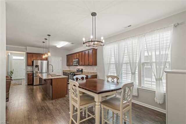 513 Simpson Ln, Chesapeake, VA 23323 - dining space with dark wood-style flooring, baseboards, and a chandelier