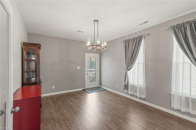 513 Simpson Ln, Chesapeake, VA 23323 - unfurnished room featuring plenty of natural light, wood finished floors, a chandelier, and baseboards