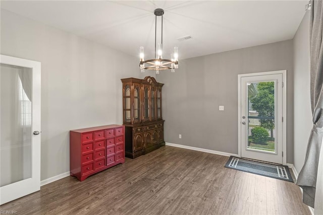 513 Simpson Ln, Chesapeake, VA 23323 - unfurnished dining area with dark wood-style floors, a chandelier, and baseboards