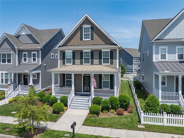 513 Simpson Ln, Chesapeake, VA 23323 - townhome / multi-family property featuring a porch, board and batten siding, a standing seam roof, and metal roof