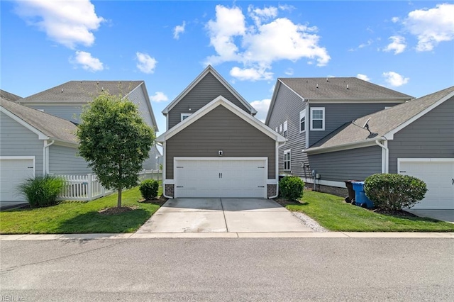 513 Simpson Ln, Chesapeake, VA 23323 - view of front of property with a garage, concrete driveway, and fence