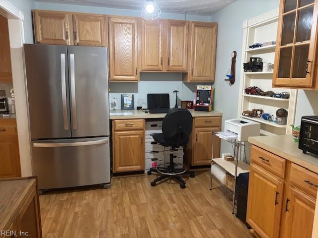 31154 Cardinal Ave, Franklin, VA 23851 - kitchen with freestanding refrigerator, light countertops, and light wood-style flooring