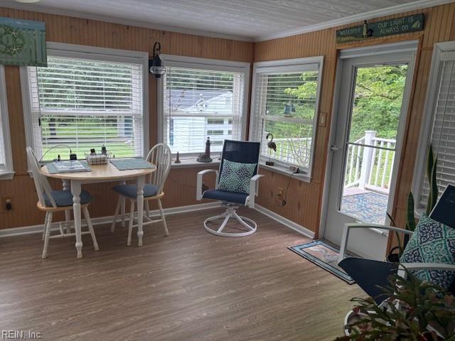 31154 Cardinal Ave, Franklin, VA 23851 - sunroom with baseboards, wood walls, wood finished floors, and crown molding