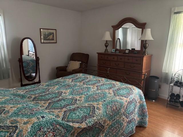 31154 Cardinal Ave, Franklin, VA 23851 - bedroom with wood finished floors, multiple windows, and baseboards