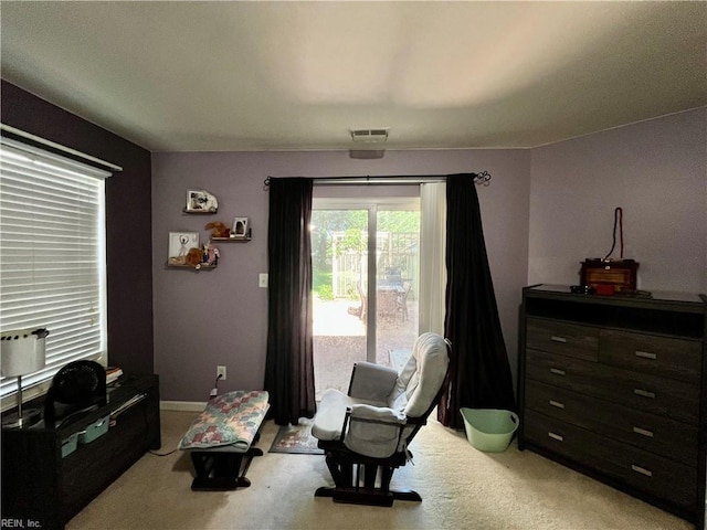 living area featuring light carpet