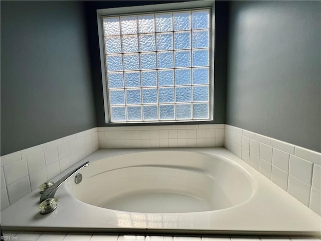 bathroom featuring healthy amount of natural light and a bath