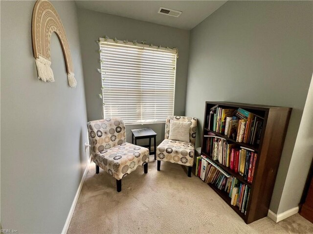 living area with carpet flooring and baseboards