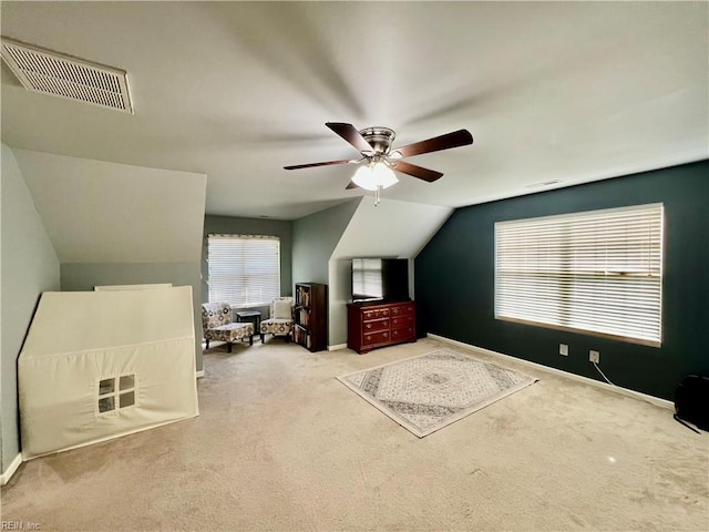 carpeted bedroom featuring vaulted ceiling, baseboards, and a ceiling fan