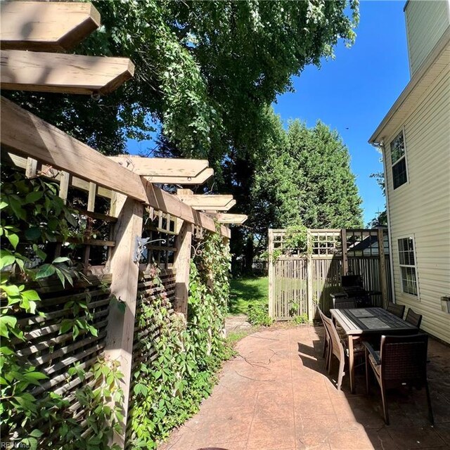 view of patio / terrace featuring outdoor dining space and fence