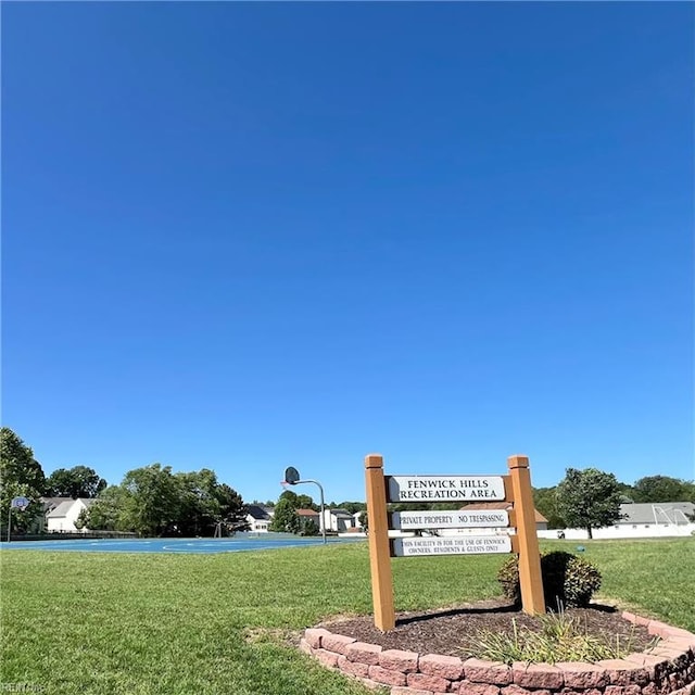 community / neighborhood sign with a lawn