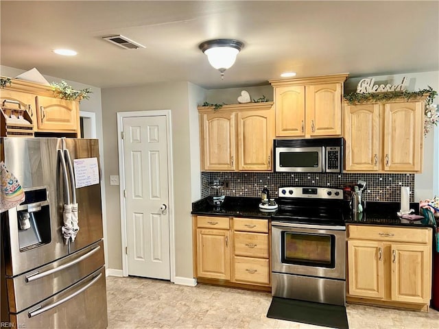kitchen featuring appliances with stainless steel finishes, light brown cabinetry, and backsplash
